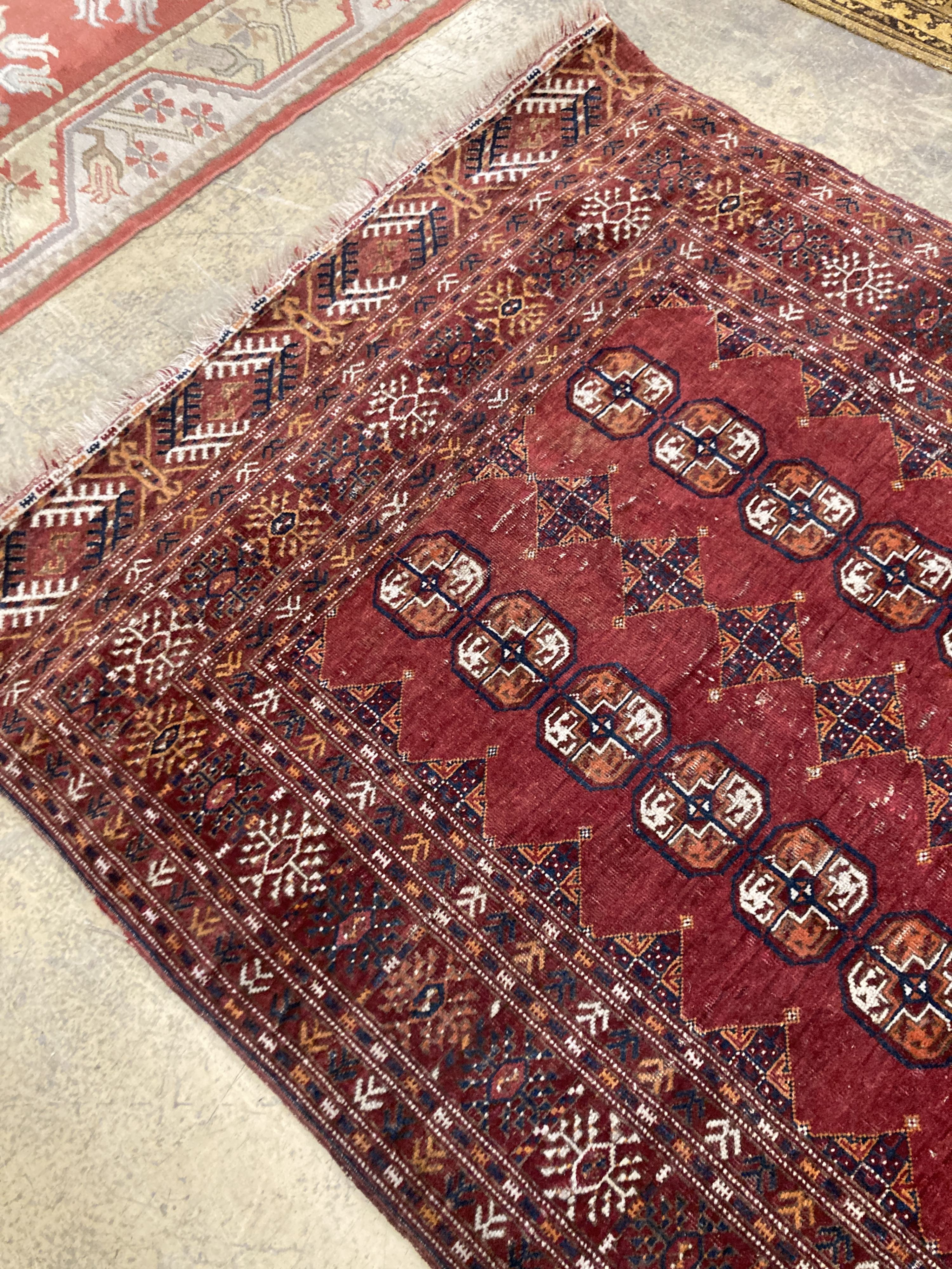 A Bokhara red ground rug, 190 x 114cm